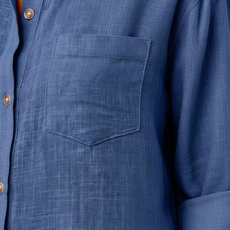 Close-up of a blue shirt with a pocket and button details