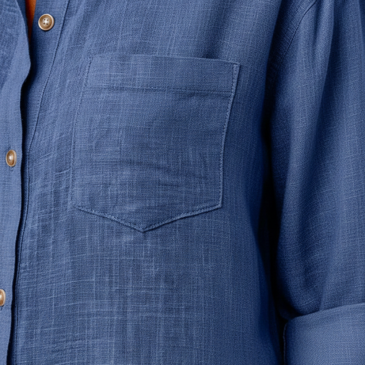 Close-up of a blue shirt with a pocket and button details