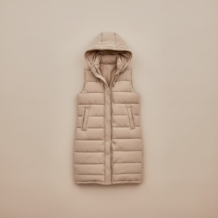 front angle of model wearing beige puffer vest highlighting long fit and zipper design