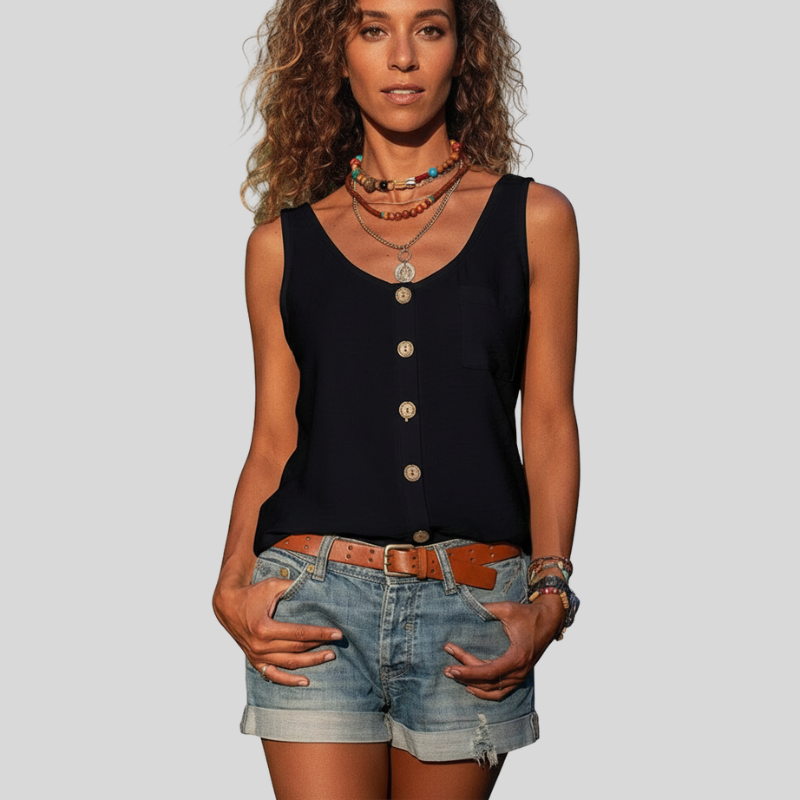 model in black buttoned sleeveless top styled with denim shorts in studio