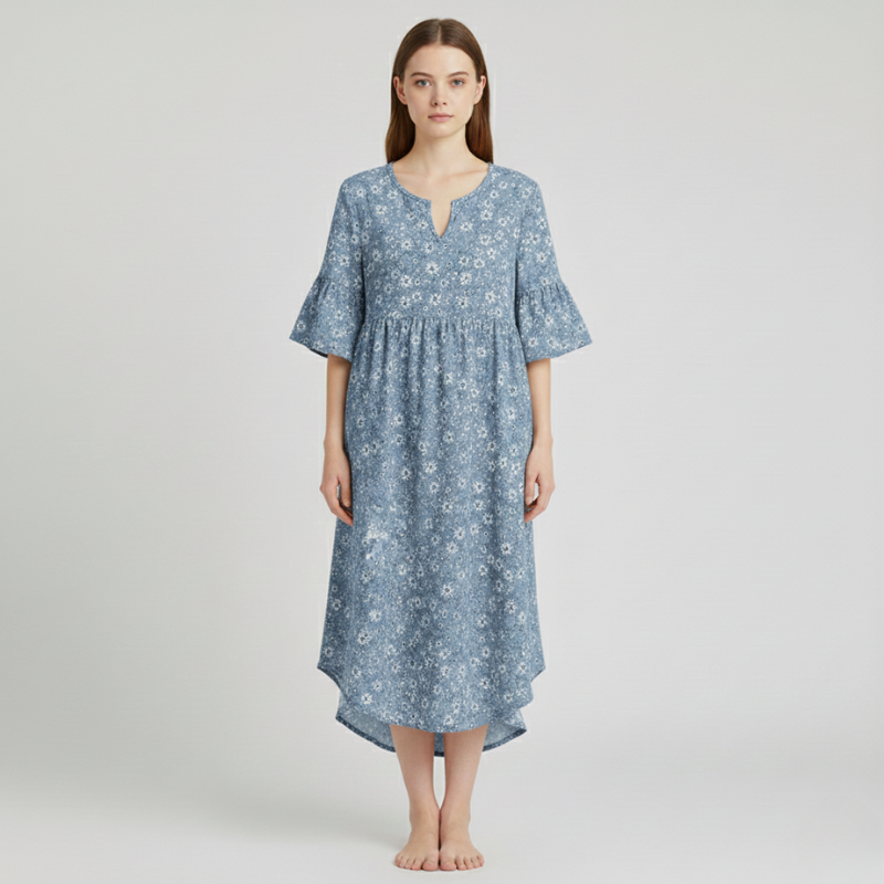 Woman wearing a blue floral dress on a light gray background