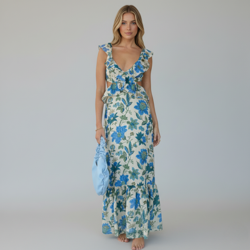 Model wearing a blue floral ruffle maxi dress in a full-length studio photograph.