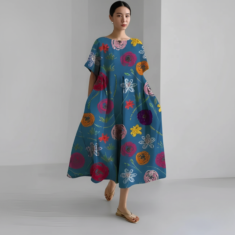 Woman wearing a colorful floral dress on a plain background