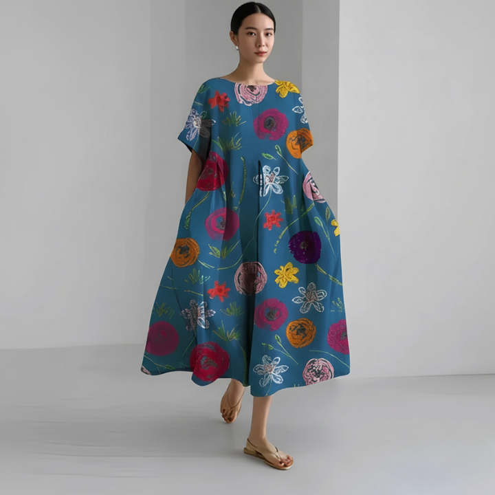 Woman wearing a colorful floral dress on a plain background