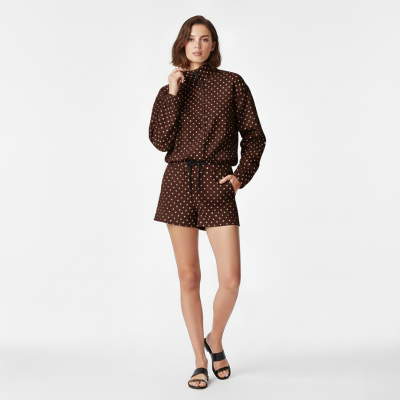 Woman wearing a brown polka dot outfit on a white background