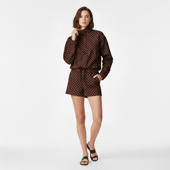 Woman wearing a brown polka dot outfit on a white background