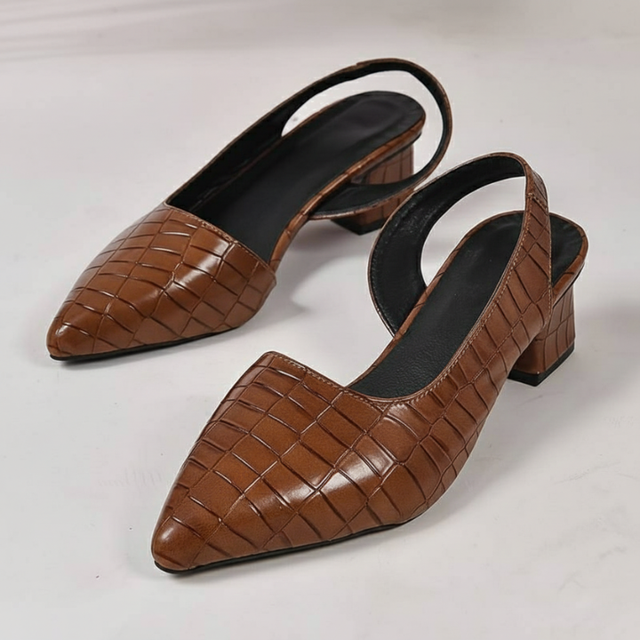 Pair of brown woven leather slingback heels displayed on a white surface showing pointed toe and block heel.