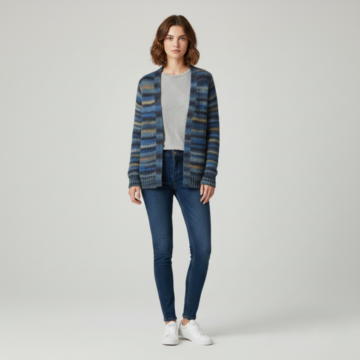 Woman wearing a blue plaid cardigan, gray shirt, and jeans on a white background