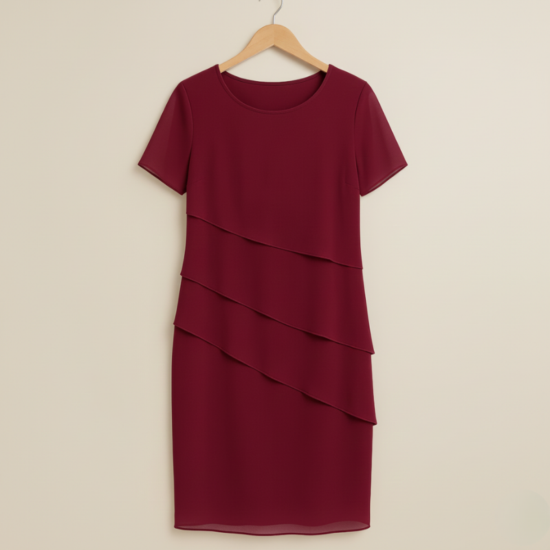 Maroon dress with layered skirt on a beige hanger against a beige background