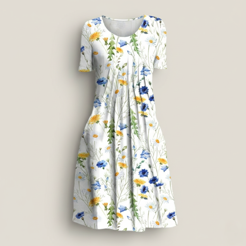 Close-up of floral dress fabric showing detailed botanical prints in blue, yellow, and green.