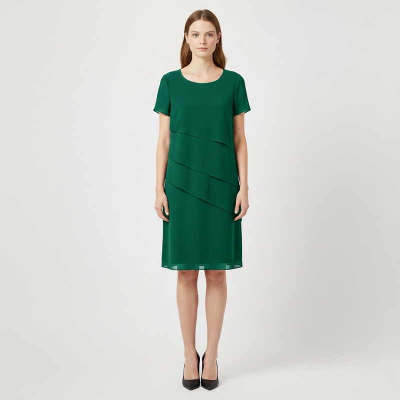 Green dress worn by a model on a white background