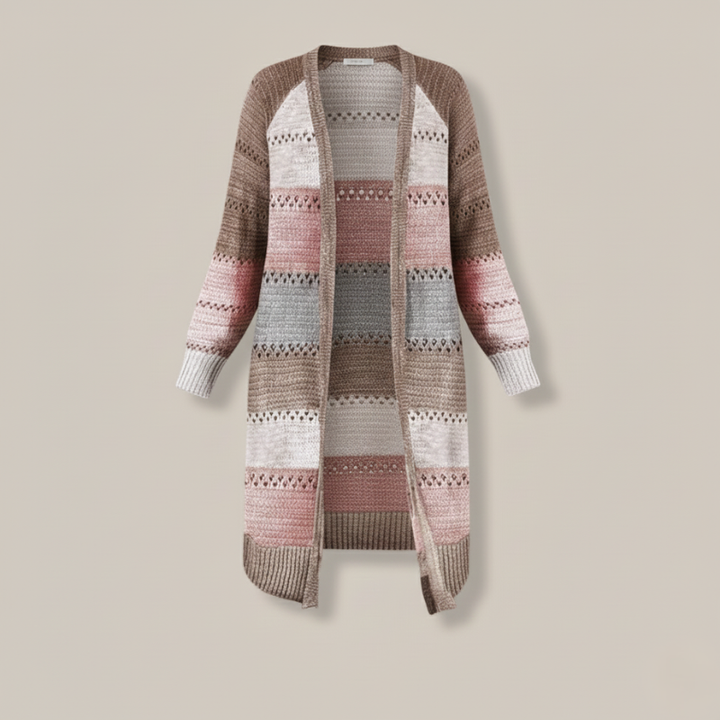 Flatlay of a long patchwork knit cardigan showing mixed color blocks, stitching, and relaxed silhouette.