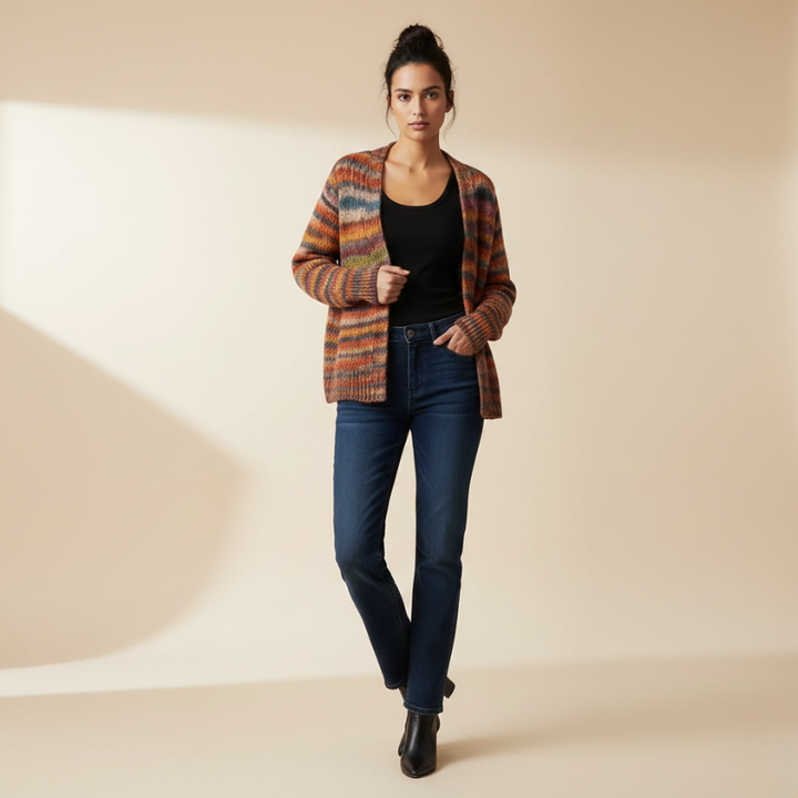 Woman wearing a plaid jacket, black top, and blue jeans on a beige background