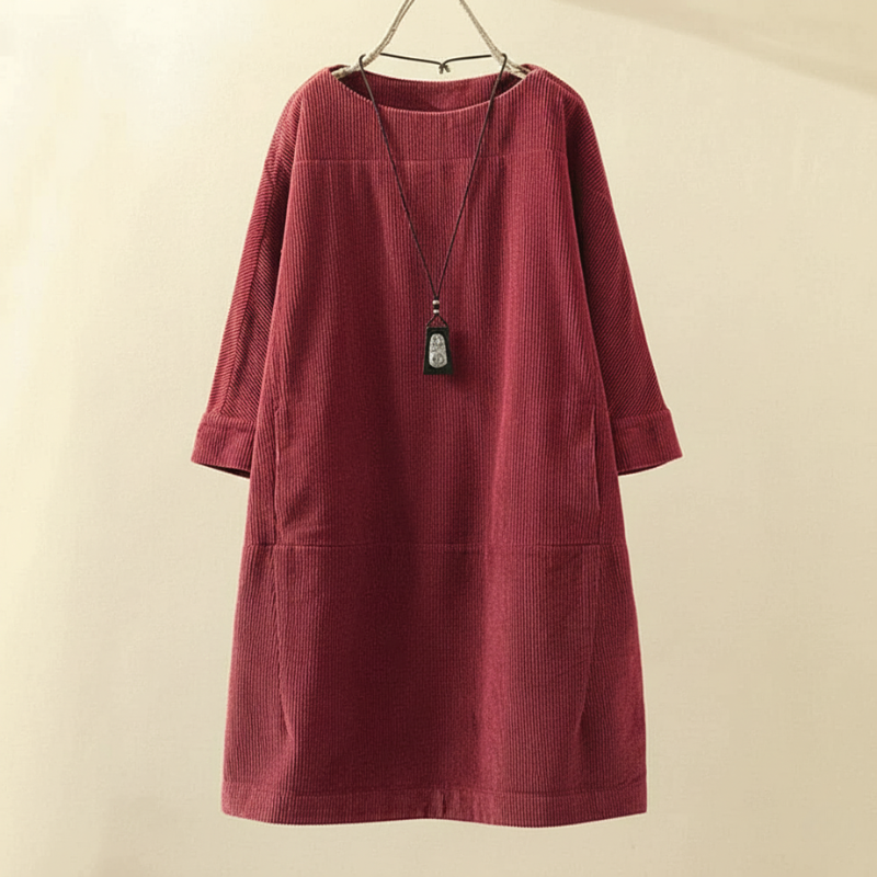 Red long-sleeve oversized dress displayed on a hanger showing its relaxed shape and textured fabric.