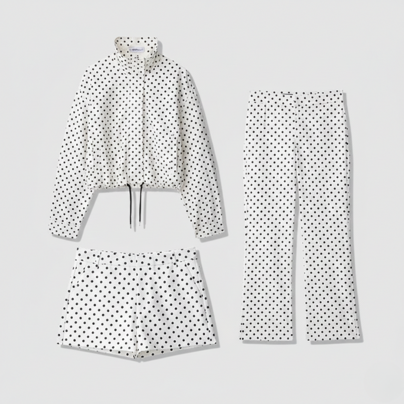 Polka dot outfit with jacket, pants, and shorts on a light gray background