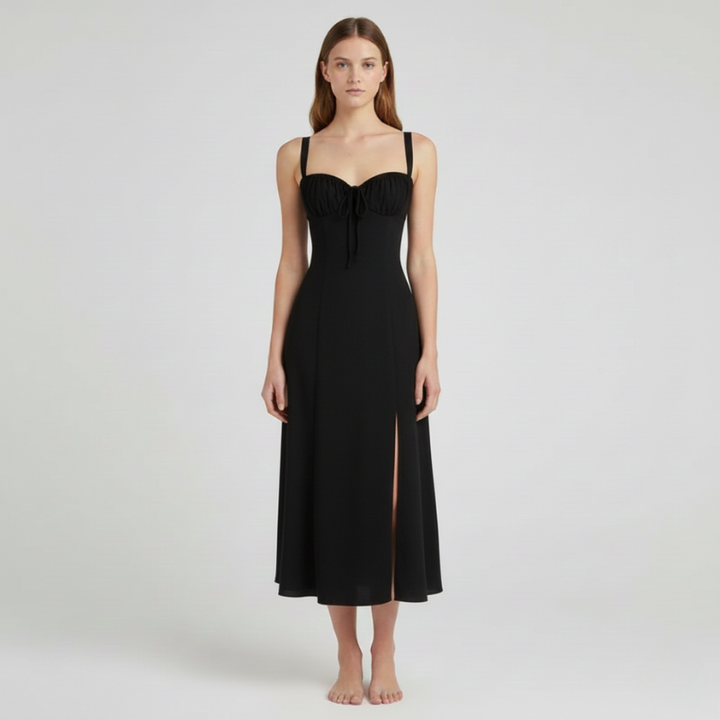 Woman wearing a black dress with a slit on a white background