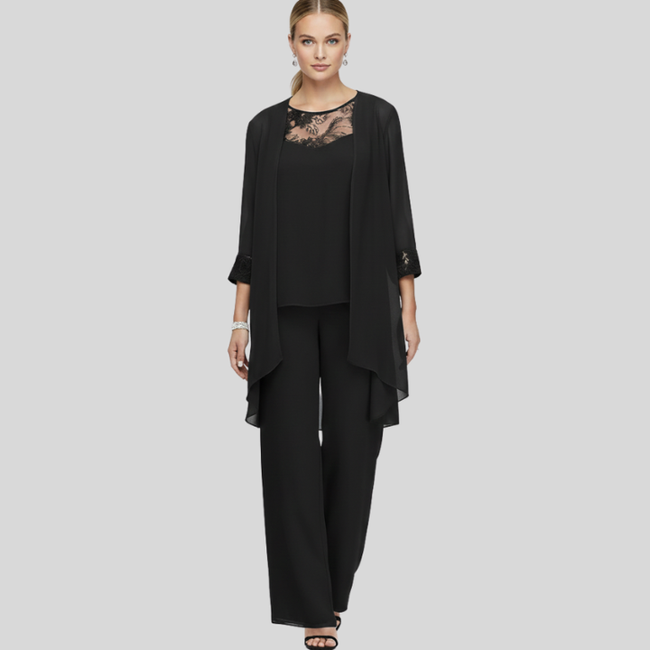 Woman wearing a black chiffon two-piece outfit featuring a lace neckline and flowy layered top.