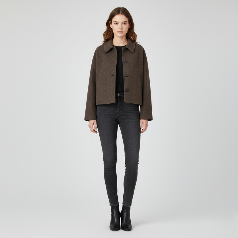 Woman wearing a brown jacket and black pants on a white background