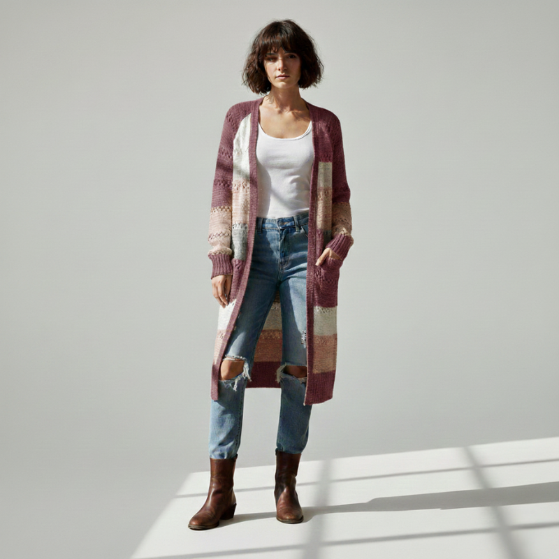 Woman wearing a neutral-toned patchwork knit cardigan with a relaxed open-front fit in clean studio lighting.