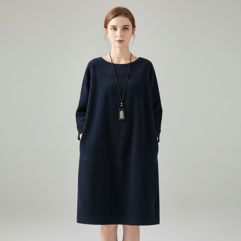 Woman wearing a navy oversized long-sleeve dress with a loose comfortable fit.