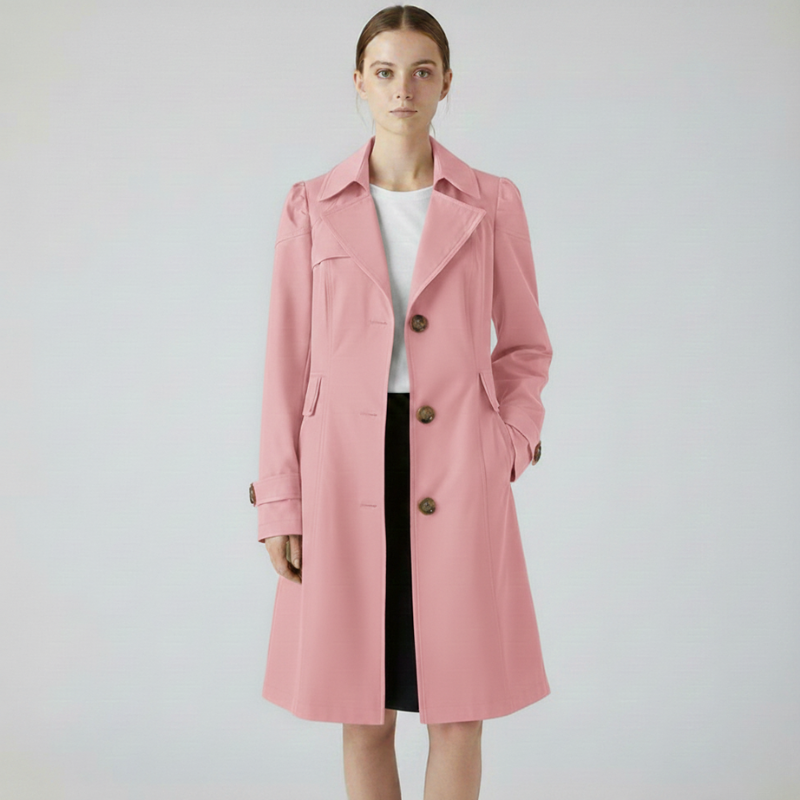 Woman wearing a pink long tailored coat styled for a polished, elegant look.