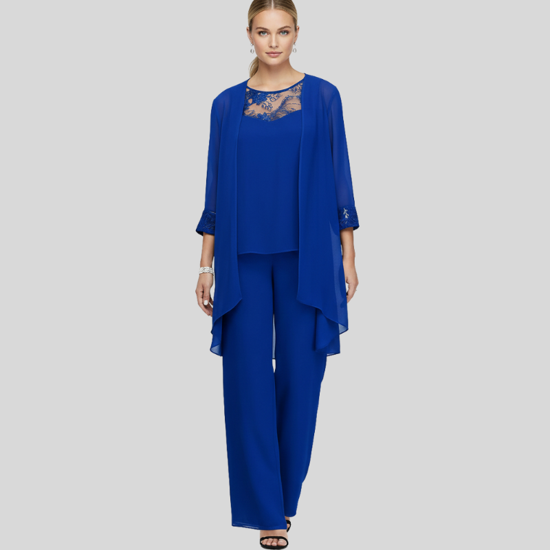 Full-body image of a woman wearing a royal blue two-piece pant set with lace neckline and layered chiffon top.