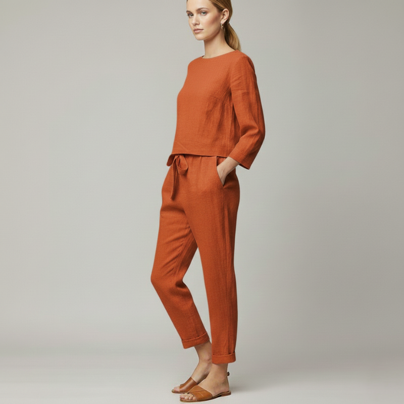 Female model in a rust-colored lounge set featuring a relaxed long-sleeve top and tapered jogger pants.